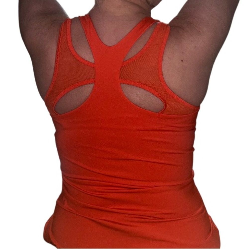Athleta in red athletic top with sports bra attached